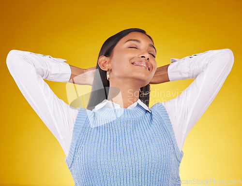 Image of Relax, happy and woman in studio smile, chilling and satisfied against gradient yellow background. Peaceful, happiness and indian female content, cheerful and carefree while leaning and isolated