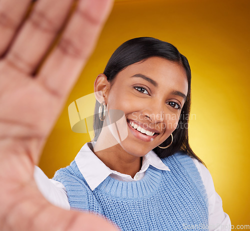 Image of Selfie, smile and portrait of Indian woman in studio for happiness, confident and cosmetics. Mockup, fashion and face of girl with hand frame in makeup, trendy clothes and happy on yellow background