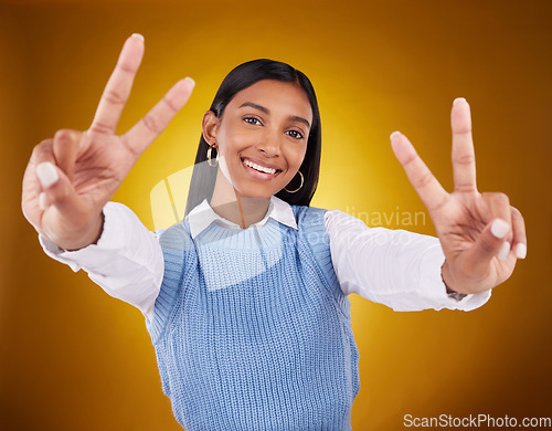 Image of Hands, peace sign and portrait of Indian woman in studio for happiness, confident and smile on brown background. Emoji mockup, fashion and girl with hand gesture with beauty, cosmetics and style