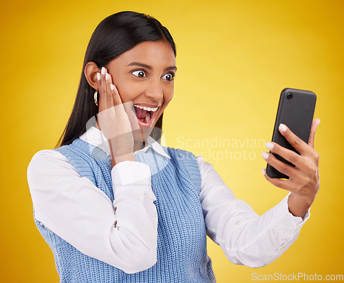 Image of Phone surprise, online news and happy woman shocked over mobile notification, app promotion or wow discount. Reading OMG info, cellphone announcement and excited studio female on yellow background