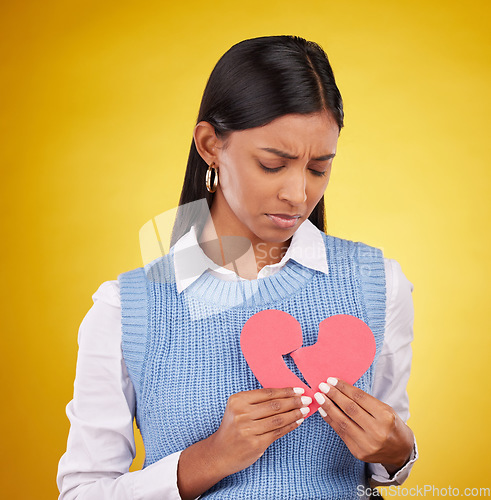 Image of Sad, unhappy and woman with broken heart, depression and problems against a studio background. Female, depressed and person with tear, symbol for love cracked and issue after breakup and anxiety