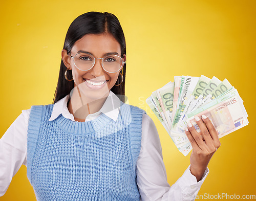 Image of Studio cash money, portrait and woman smile for lottery prize, competition win or dollar bills award. Finance winner, payment or person winning poker, giveaway or casino gambling on yellow background