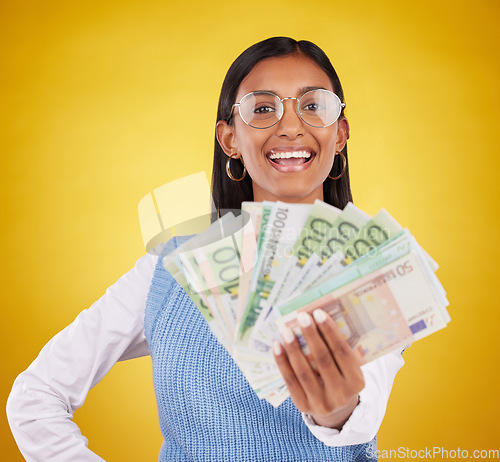 Image of Money bills, studio portrait and woman smile for lottery win, competition giveaway or cash award. Finance bonus, payment or prize winner of poker, bingo or casino gambling on yellow background