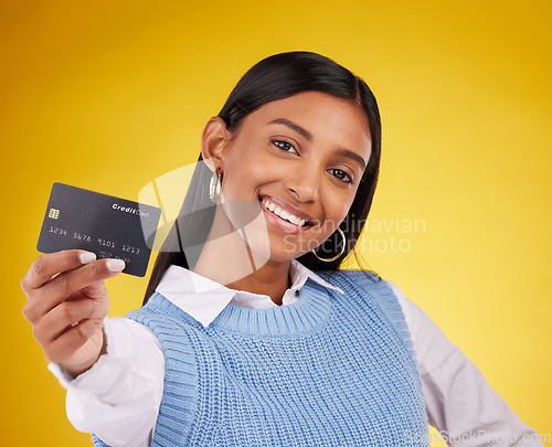 Image of Credit card, portrait and Indian woman on yellow background for bank, investment and payment in studio. Banking mockup, finance and happy girl with plastic for budget, commerce and promotion purchase