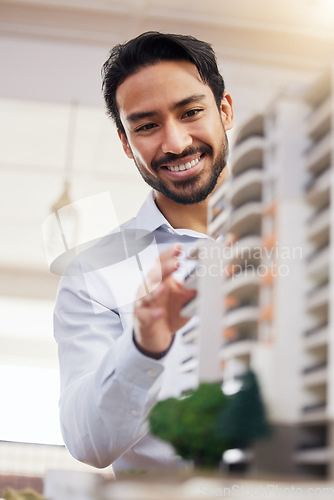 Image of Architect, happy man and check architecture model, construction and building with smile on face and building project. Businessman in office, design and engineer, property development and construction