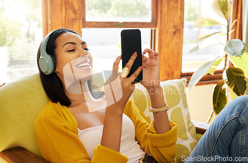 Image of Woman, smartphone and headphones, smile at social media and communication, technology and listening to music. Online chat, happy female relax at home with app and podcast, games and scroll internet