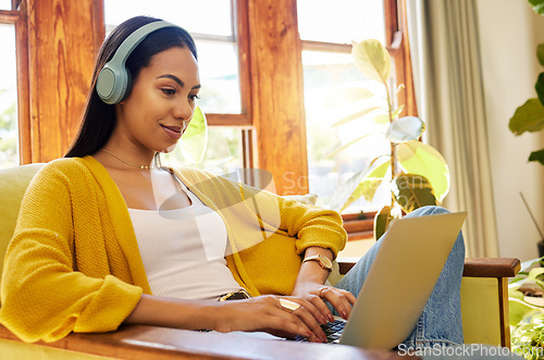 Image of Woman, laptop and remote work, headphones for listening to music while working from home. Female freelancer, copywriter for blog or website with radio or podcast streaming, typing and productivity
