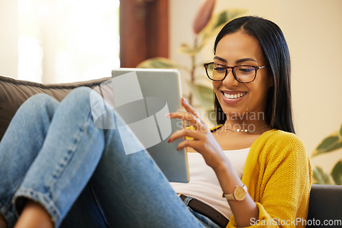 Image of Tablet, relax and woman reading in home living room on sofa, social media or ebook. Technology, touchscreen and happy person web scrolling, online browsing or streaming video, movie or film in lounge