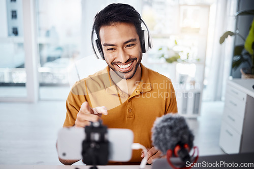 Image of Podcast, pointing and live streaming with a man influencer recording broadcast content in his home office. Internet, streamer and subscription with a male freelancer or creator working in his studio