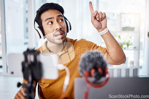 Image of Podcast, pointing and live stream with a man influencer recording broadcast content in his home office. Internet, freelance and subscription with a male vlogger or creator working in his studio