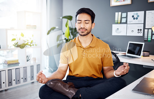 Image of Office, yoga and business man in office for break, mental health and breathing exercise at a desk. Corporate, meditation and asian guy manager meditating for stress management, zen and peace in Japan