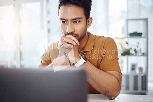 Image of Laptop, business and Asian man with focus, thinking and ideas for new project, creativity or online reading. Male entrepreneur, professional or worker with technology, decision or choices for startup