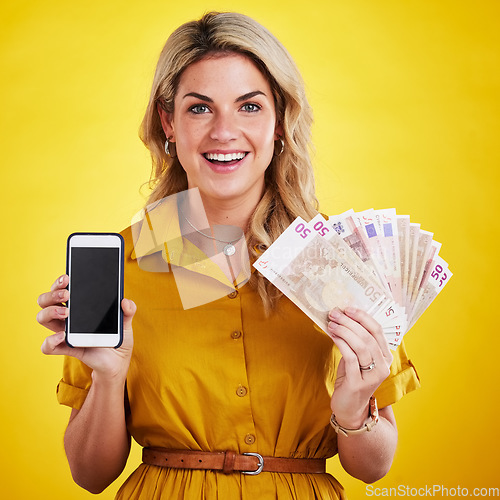 Image of Portrait, smile and woman with phone and money in studio isolated on a yellow background mockup. Cellphone, euros and happiness of female person with cash after winning lottery, prize or competition
