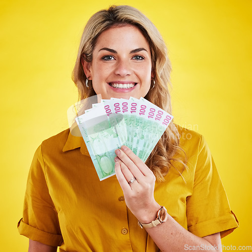 Image of Smile, portrait and woman with money fan in studio isolated on a yellow background. Winner, financial freedom and rich female person with cash or euros after winning lottery, prize or competition.