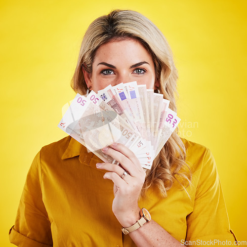 Image of Portrait, euros and woman with money fan in studio isolated on a yellow background. Winner, financial freedom and rich female person with cash profit after winning lottery, bonus prize or competition