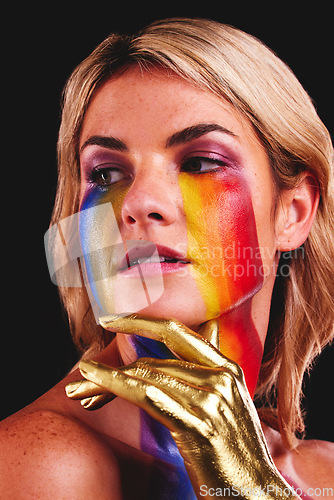 Image of Woman, gold hand and beauty with color paint cosmetics on skin and face in studio. Female model person on a black background for art deco, fantasy and creative rainbow makeup for lgbtq or gay pride