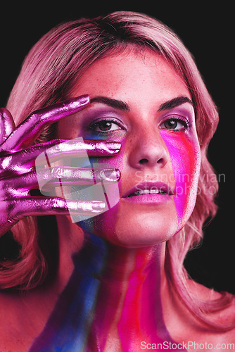 Image of Woman, hand on face and beauty portrait with metallic color paint cosmetics on skin in studio. Female model person on a black background for art deco, fantasy and creative makeup with a neon light