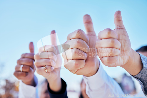 Image of Business people, hands and thumbs up for teamwork, success or winning in thank you and good job outdoors. Hand of group showing thumb emoji, yes sign or like for team approval or ok with blue sky