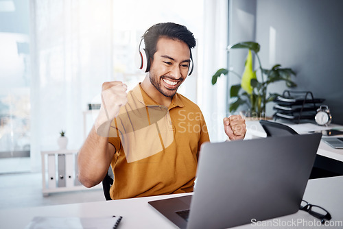 Image of Business man, laptop and success with headphones to listen to music, audio or video call. Asian male entrepreneur at desk with a smile and hands to celebrate achievement, online target or goals