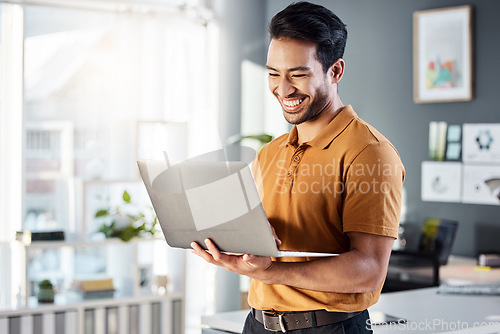 Image of Laptop, office and happy man for online planning, website design and software management at tech company. Creative asian person, designer or employee on computer or technology for web 3.0 review