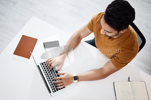 Image of Top view, business man typing and laptop in office for planning schedule, web research and seo job. Businessman, computer or website management in startup company for analysis, focus or communication