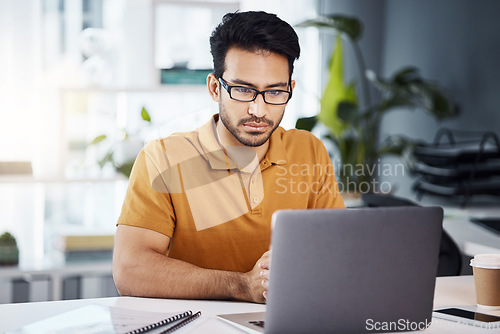 Image of Focus, laptop and business man with online data analytics, market research and social media review in office. Serious, planning and analyst or asian person on computer for company website management