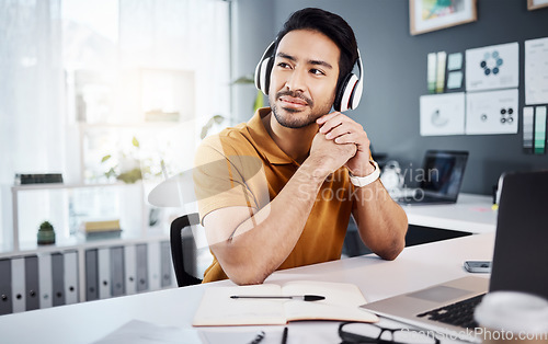 Image of Business man, thinking and headphones to listening to music, audio or podcast. Asian male entrepreneur at desk with headset to think of ideas, strategy and plan for growth development and future