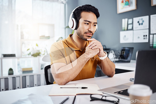 Image of Thinking, laptop and headphones on business man listening to music, audio or webinar. Asian male entrepreneur with technology for planning strategy, idea or reading email or communication on internet