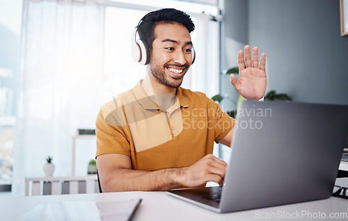 Image of Headphones, laptop and man on video call, webinar or virtual meeting, talking and online in work from home office. Happy Asian person waves hello on his computer pc in client chat for tech business