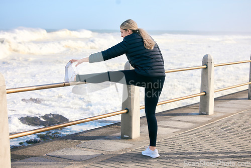 Image of Fitness, woman and stretching legs at the beach for training, running and morning cardio routine outdoors. Runner, warm up and girl stretch before exercise, sports and performance workout at the sea