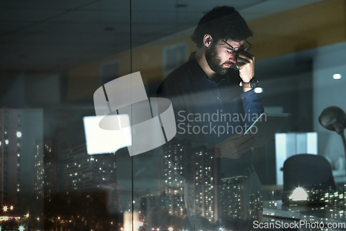 Image of Business man, tablet and headache, pain or migraine in office by widow with city lights at night. Technology, fatigue or person with depression, brain fog or anxiety, stress or burnout with deadline.