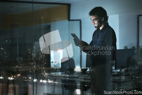 Image of Business man, tablet and smile in office, online browsing or internet scroll by window with city lights at night. Technology, happiness and professional person with touchscreen for research deadline.