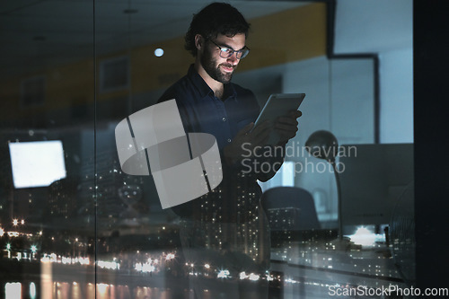 Image of Business man, tablet and research in office, online browsing or internet scrolling by window with city lights at night. Technology, happiness and professional person with touchscreen for deadline.