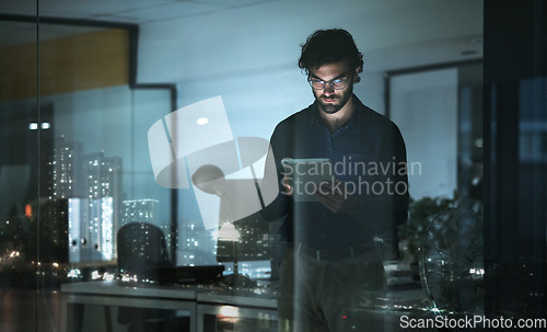 Image of Business man, tablet and serious in office, online browsing or web scroll by window with city lights at night. Technology, working late and professional person with touchscreen for research deadline.