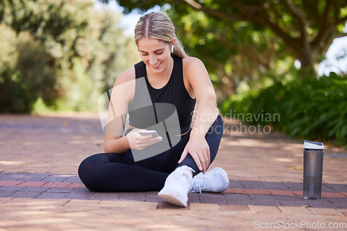 Image of Relax, phone and fitness with woman in park for social media, network and technology. Running, workout and training with female runner in nature for connection, communication and connection