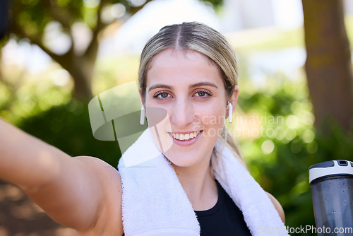 Image of Portrait, happy woman or fitness influencer taking a selfie at training, running or workout in a park. Smile, runner or healthy girl athlete in headphones talking pictures or photo on social media