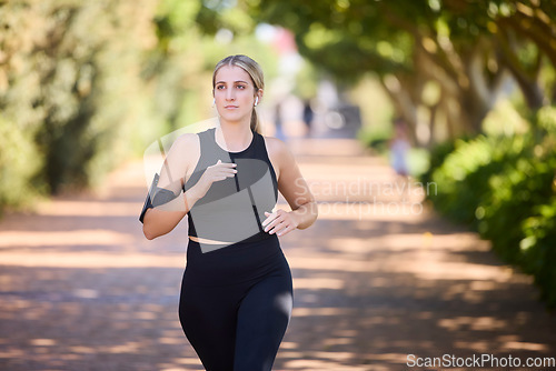 Image of Music, runner or girl running in park training, cardio exercise or endurance workout for marathon. Sports, fitness or healthy athlete woman exercising on jog streaming audio or radio song in nature