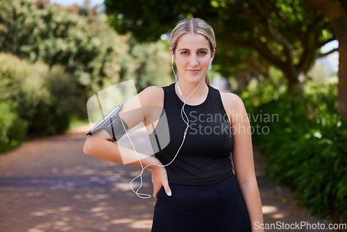 Image of Headphones, runner or portrait of woman in park training, exercise or workout for a healthy body. Wellness, fitness break or sports girl athlete exercising or streaming audio or radio song in nature