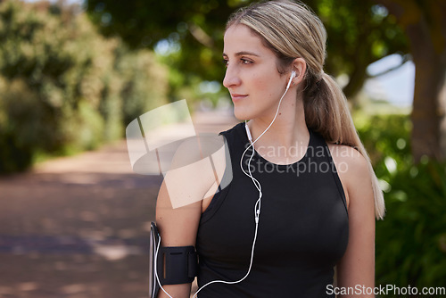 Image of Headphones, runner or side of woman in park training, exercise or workout for a healthy body. Wellness, fitness profile or sports girl athlete exercising or streaming audio or radio song in nature