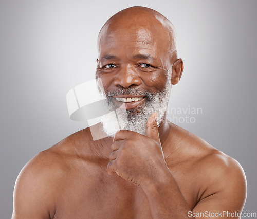Image of Happy senior black man, portrait smile and skincare for personal hygiene or profile against a gray studio background. African American elderly male smiling with beard for healthy or perfect skin