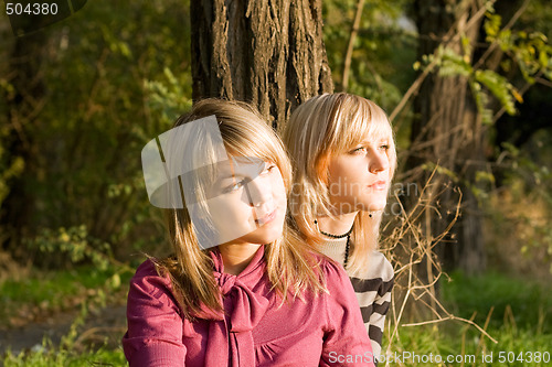 Image of Two beauty young blondes in the light of the sunset