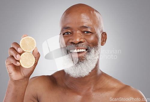 Image of Senior black man, portrait smile and fruit for vitamin C, skincare or natural nutrition against gray studio background. Happy African American male and citrus lemon for healthy skin, diet or wellness