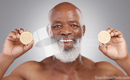 Image of Senior black man, portrait and fruit for vitamin C, skincare or natural nutrition against gray studio background. Happy African American male smile and citrus lemon for healthy skin, diet or wellness