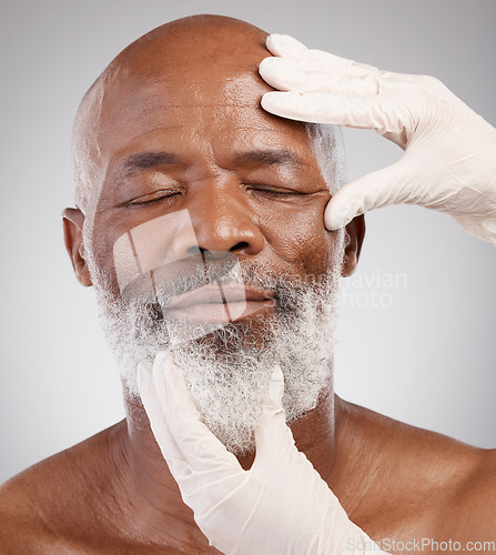 Image of Skincare, hands or gloves for black man in cosmetic treatment, professional anti ageing or white background. Dermatology, face and mature male model at salon or clinic for medical skin care in studio