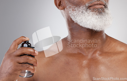 Image of Closeup, cosmetics and black man with spray, beauty and skincare with guy on studio background. Senior male model, perfume and mature person with morning routine, grooming and fragrance for self care