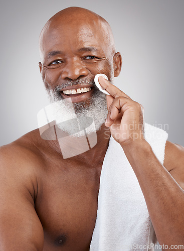 Image of Skincare, cotton pad and portrait of black man with happiness, cleaning and anti ageing treatment. Dermatology, cosmetic process and happy, mature model with smile and cleansing routine in studio.