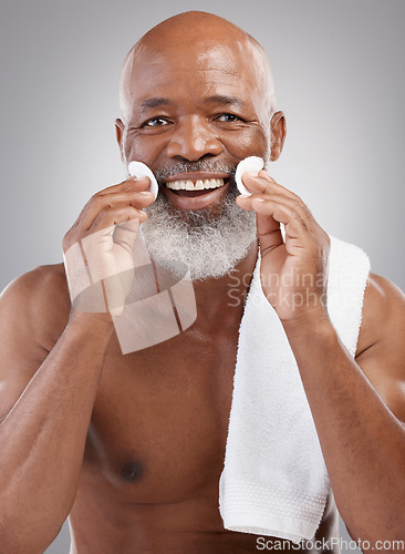 Image of Skincare, portrait and cleansing pad for man with smile, happiness and grooming with anti ageing facial treatment. Dermatology, cleaning and happy, mature and African model with cotton pads in hands