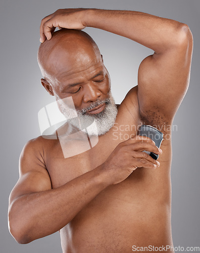 Image of Skincare, deodorant and black man with cosmetics, hygiene and beauty with guy against a dark studio background. Senior male, happy person and model with product, fragrance and wellness for aroma