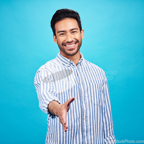 Image of Handshake, interview and portrait of business man on blue background for thank you, welcome and deal. Recruitment, hiring and male shaking hands for opportunity, agreement and onboarding in studio