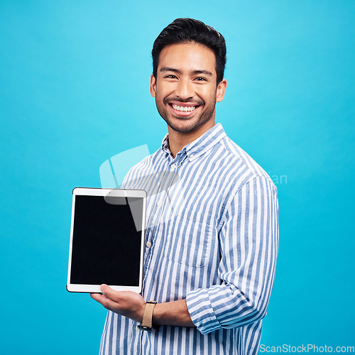 Image of Man, tablet and mockup screen, smile in portrait and digital device marketing with tech on blue background. Wireless touchscreen, website or internet branding, advertising and happy male in studio